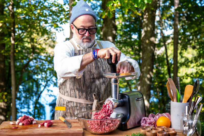 Andrew Zimmern grinds bison meat