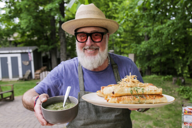 Andrew Zimmern with squab taquitos