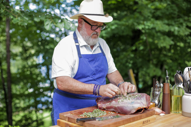 Andrew Zimmern seasons a whole antelope leg on Wild Game Kitchen.