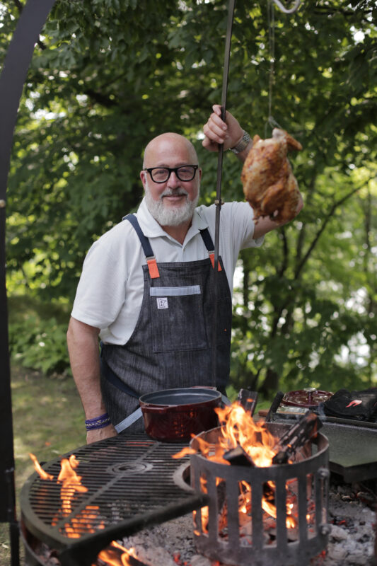 Andrew Zimmern slow roasts a whole pheasant over an open fire on Wild Game Kitchen. 